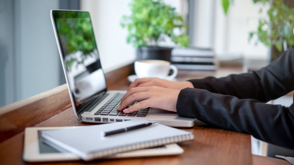 Close up of a person typing on a laptop